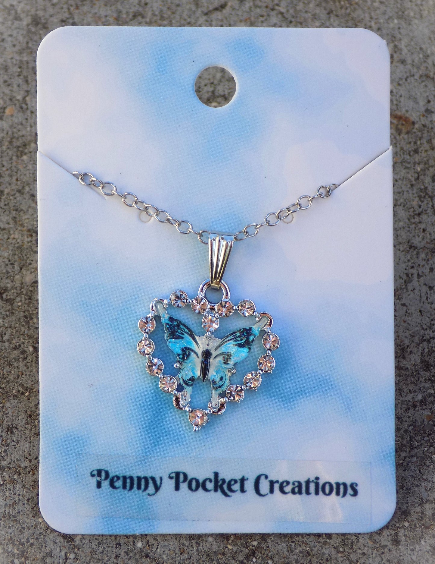 Silvery Sparkling Necklace: Colorful Resin Butterfly framed by Rhinestone Heart