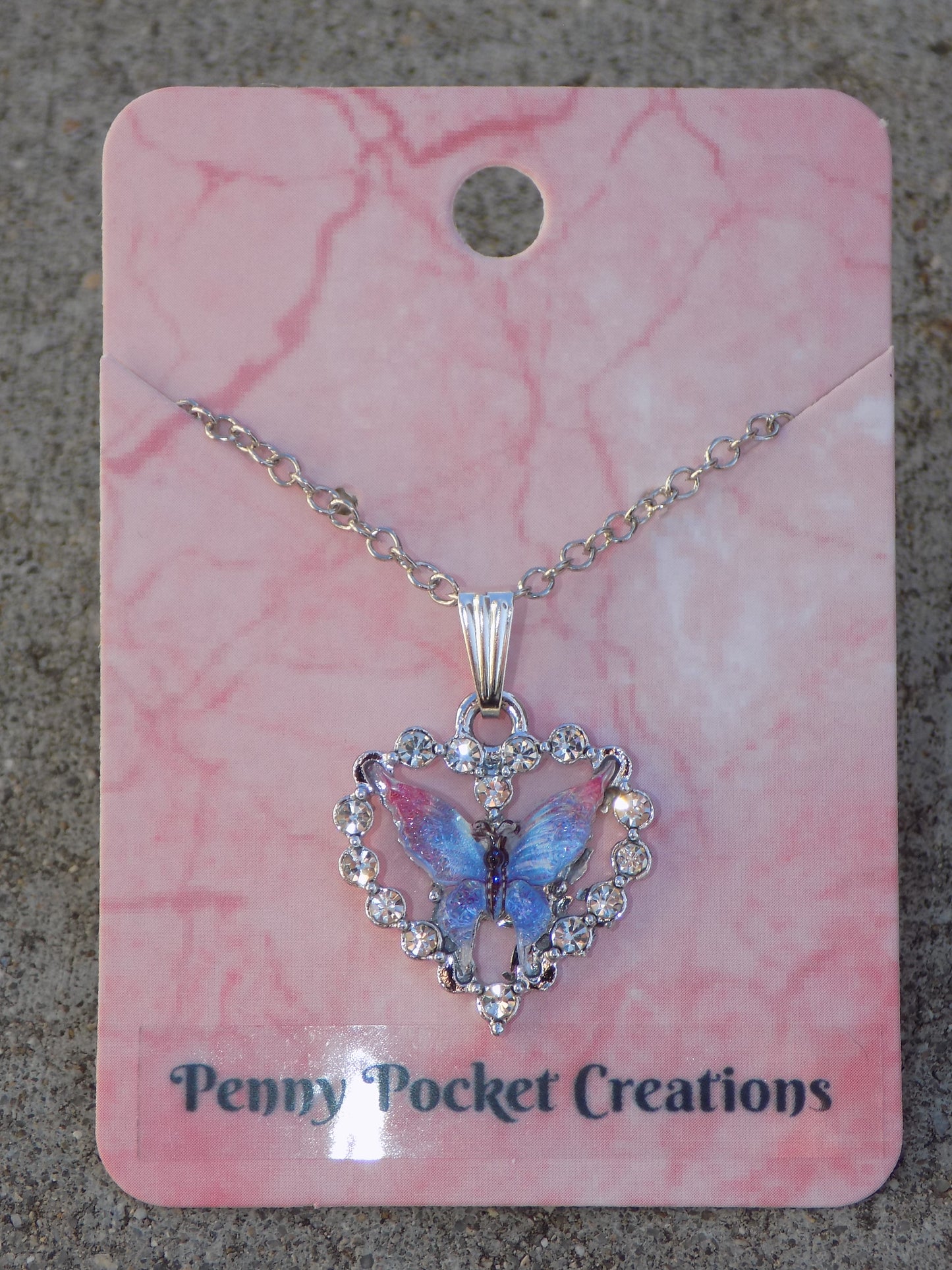 Silvery Sparkling Necklace: Colorful Resin Butterfly framed by Rhinestone Heart