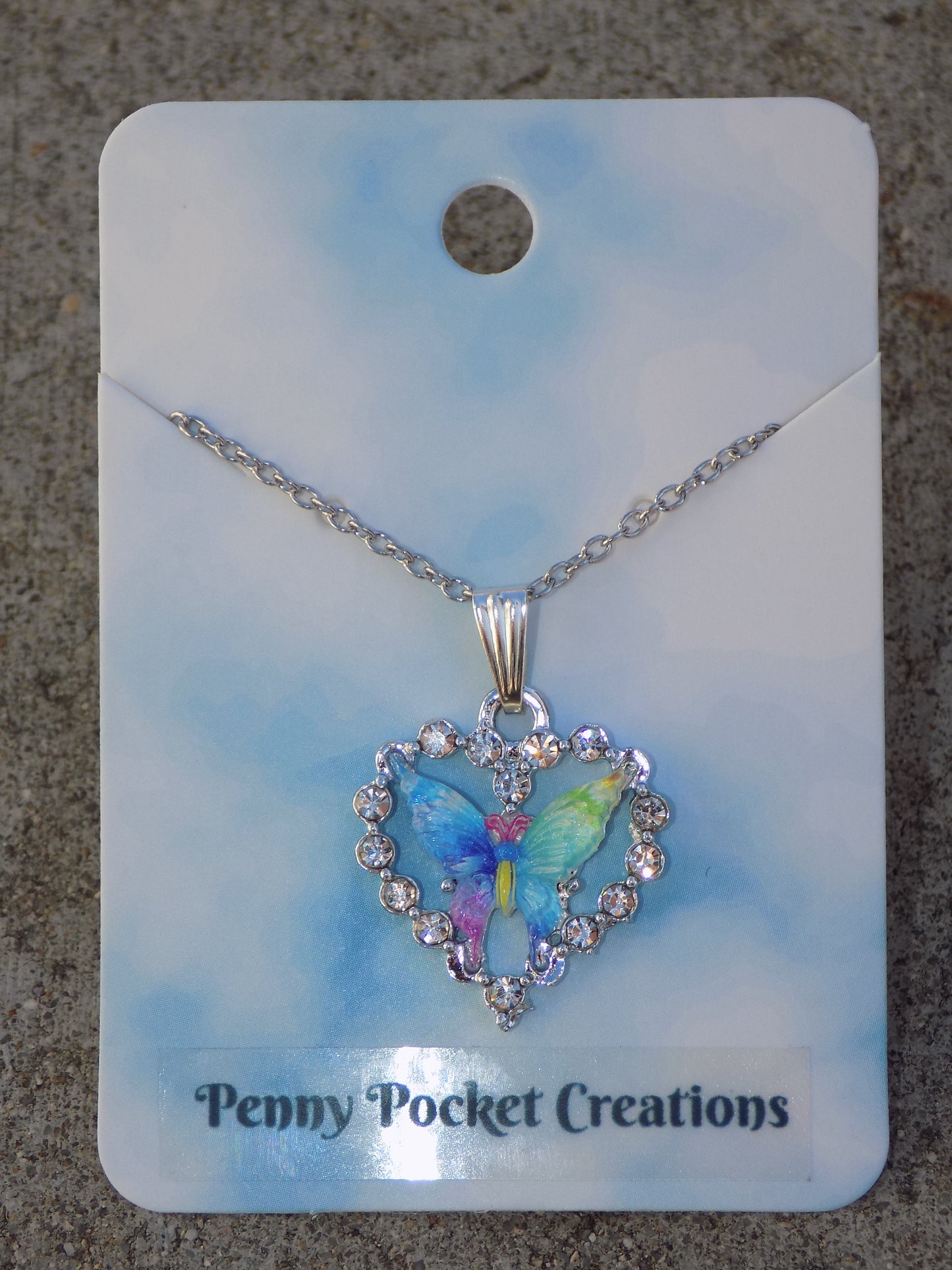 Silvery Sparkling Necklace: Colorful Resin Butterfly framed by Rhinestone Heart